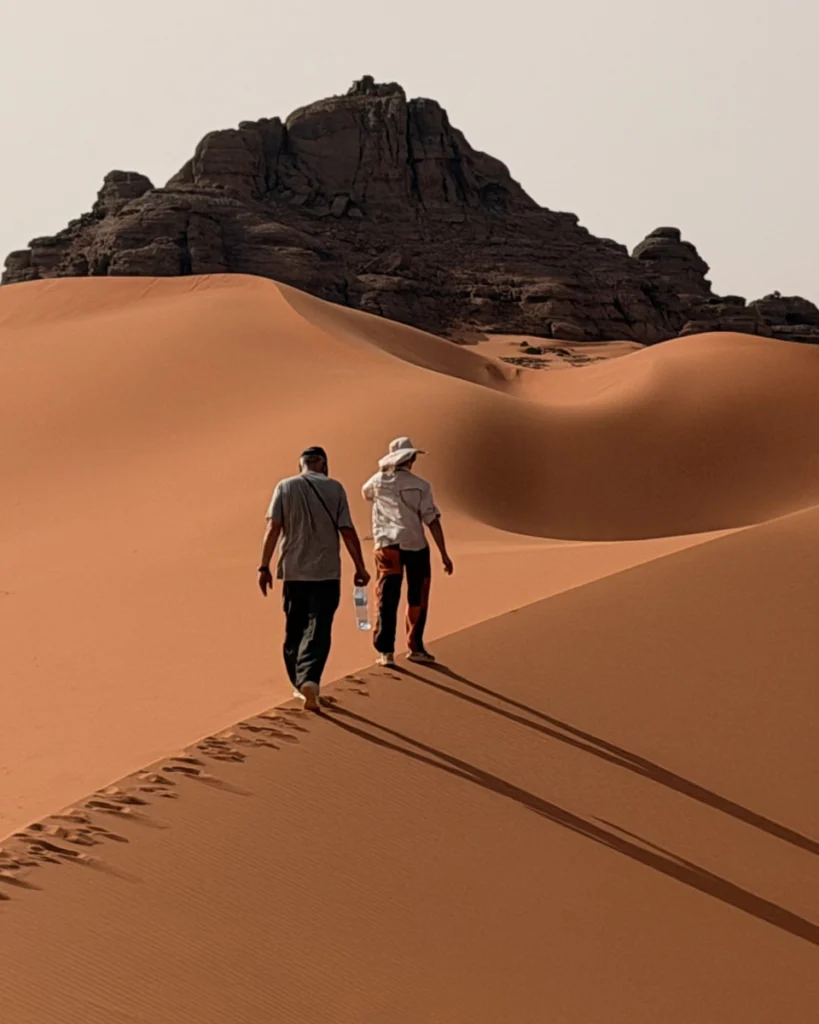 Vladimir and Lena Walking on huge dunes in Djanet
