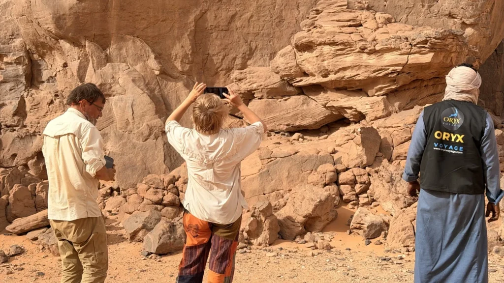 tourists exploring tassili najjer with tuareg guide