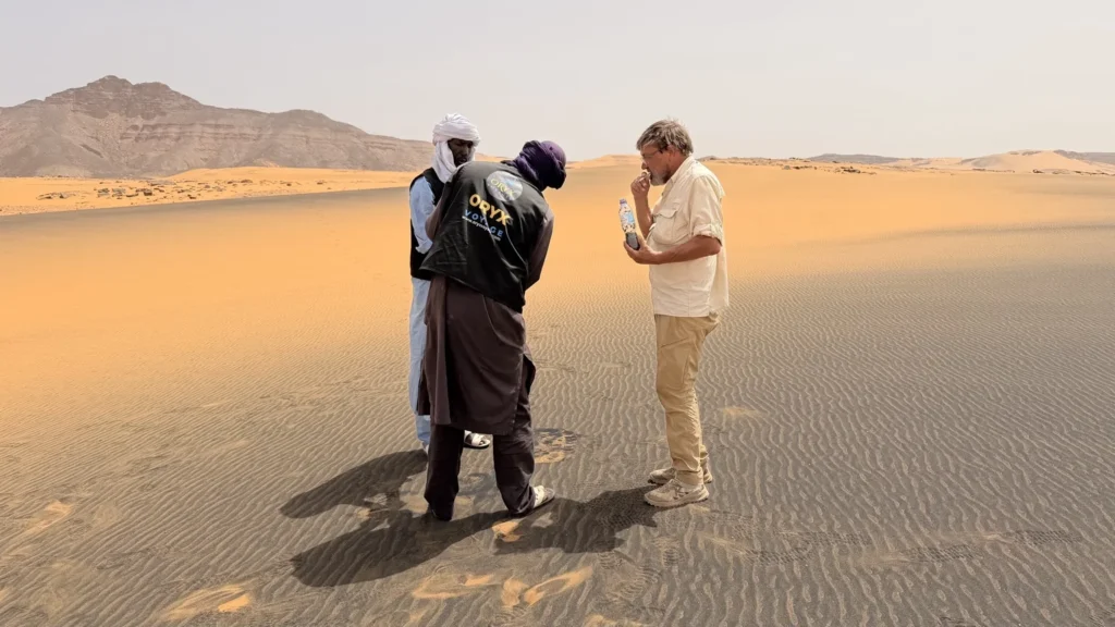 tuareg guides assisting traveler sahara djanet